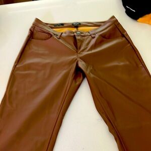 Brown pleather pants with tags.